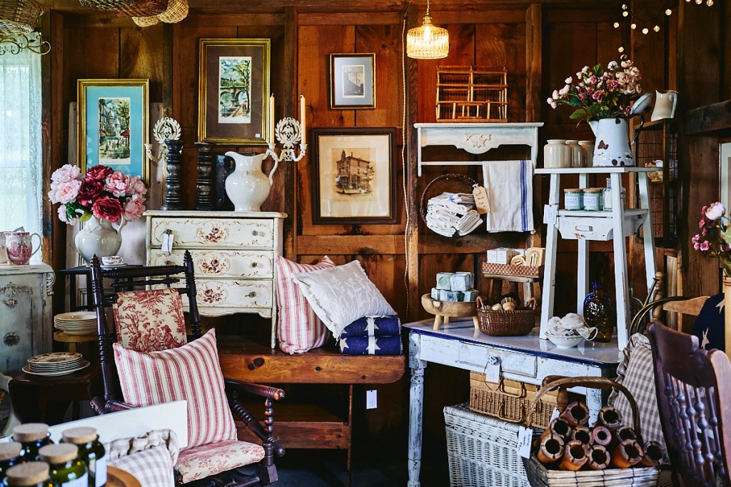 vintage furniture, clothing and items inside historic barn in Vermont